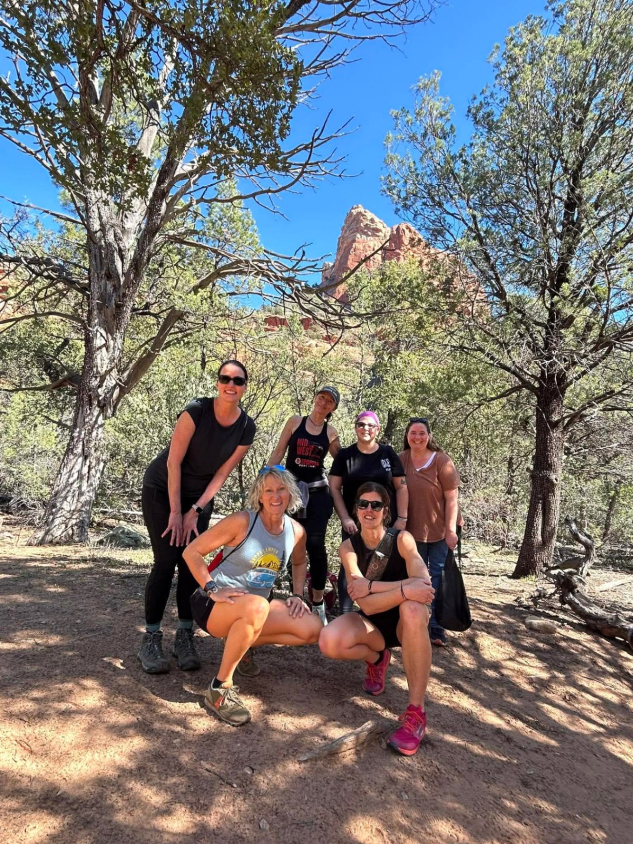 A group of women hiking and exploring Sedona red rock country together